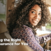 a Black woman at the wheel of a car contemplates the right auto insurance for her