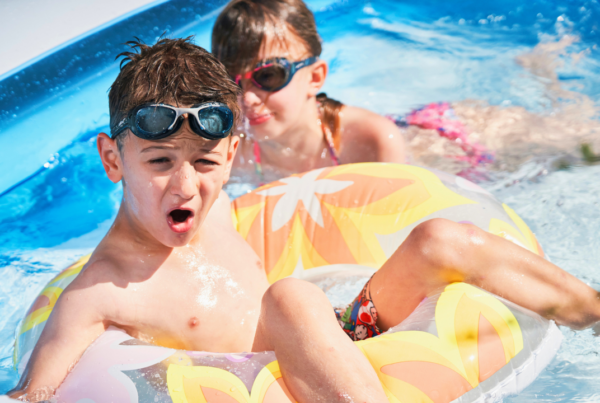 kids float on inflatable toys in a backyard pool