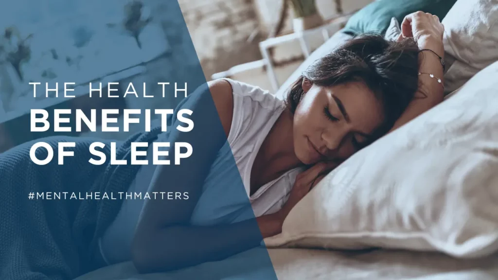 An image promoting the health benefits of sleep, with the text 'The Health Benefits of Sleep' prominently displayed at the top. The hashtag '#MENTALHEALTHMATTERS' is featured at the bottom. The visual is split into two sections: on the right, there's a young woman peacefully sleeping in bed, suggesting restfulness and tranquility, and on the left, a blue overlay covering a part of the image adds a calm and serene atmosphere to the message
