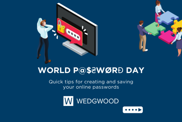 An isometric graphic representing World Password Day. The image features a large computer monitor displaying a password input screen with a security icon. In the foreground, a woman appears stressed, holding her head. Around the monitor, four individuals collaboratively fit together jigsaw puzzle pieces, symbolizing teamwork and problem-solving in cybersecurity. The image includes the logo of Wedgwood Insurance and the text 'WORLD P@$2WORD DAY - Quick tips for creating and saving your online passwords. The overall theme is to promote the use of strong passwords.
